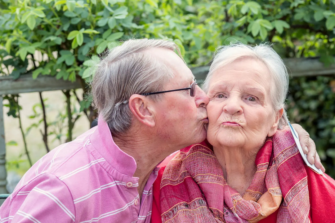 Son showing affection to his elderly mother at home, representing family-led dementia care and support