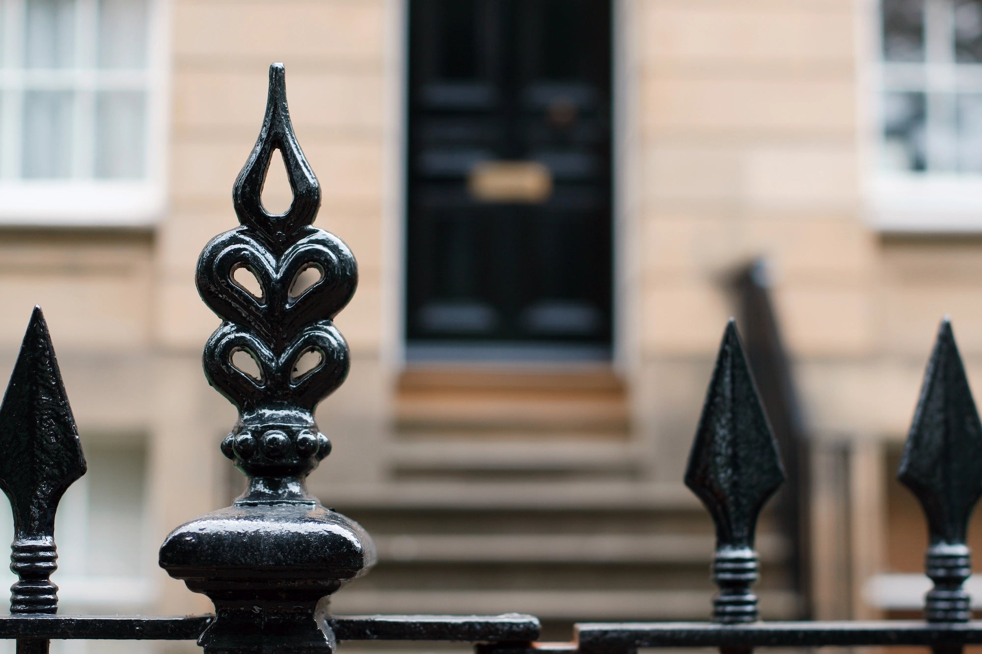 Elegant London home with black railing and black door