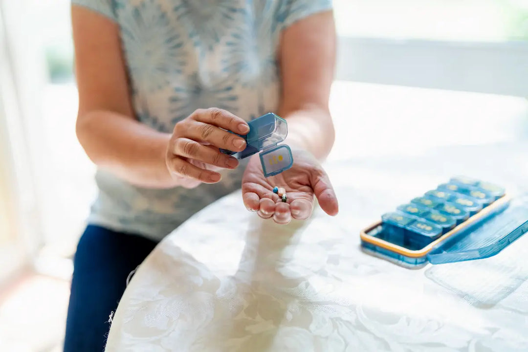 Live-in carer preparing medication for a client at home in the UK